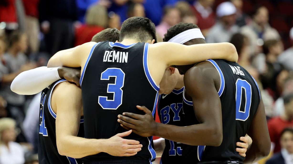 BYU players hug during the first half of an NCAA Sweet 16 basketball game against the Alabama Crimson Tide at the Prudential Center in Newark, N.J., on Thursday, March 27, 2025. BYU lost 113-88.