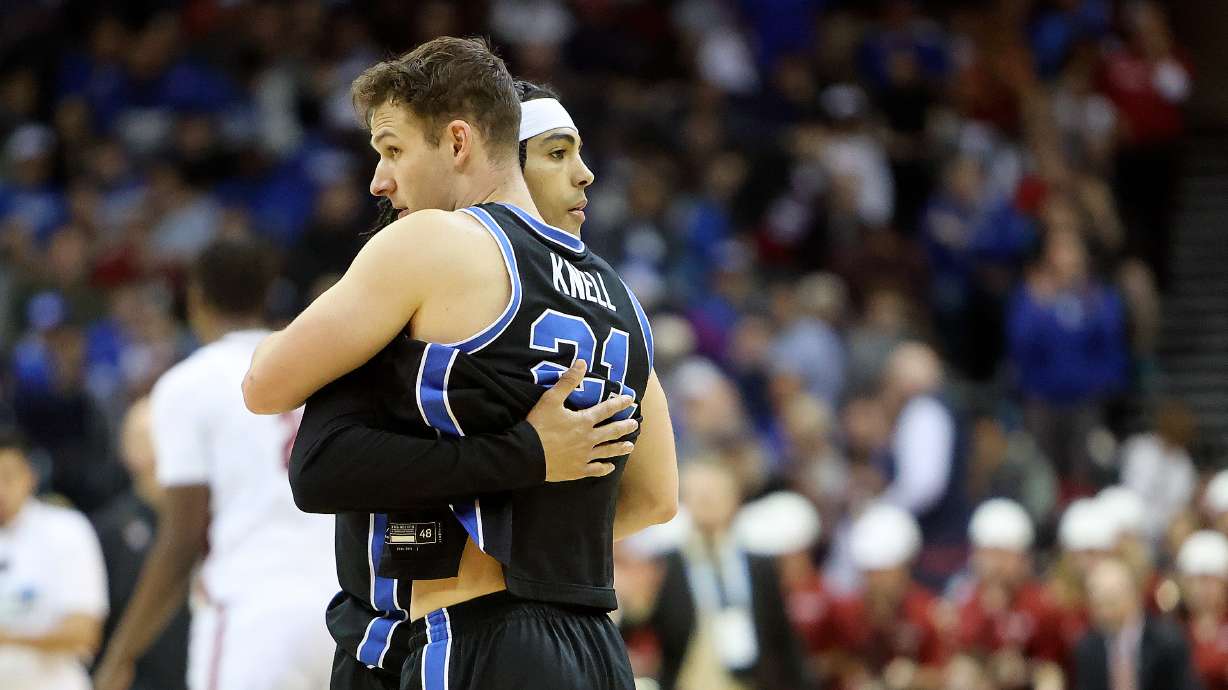 Brigham Young Cougars guard Trey Stewart (1) and Brigham Young Cougars guard Trevin Knell (21) hug after the Brigham Young Cougars lost to the Alabama Crimson Tide in an NCAA Sweet 16 basketball game at the Prudential Center in Newark, N.J., on Thursday, March 27, 2025. BYU lost 113-88.