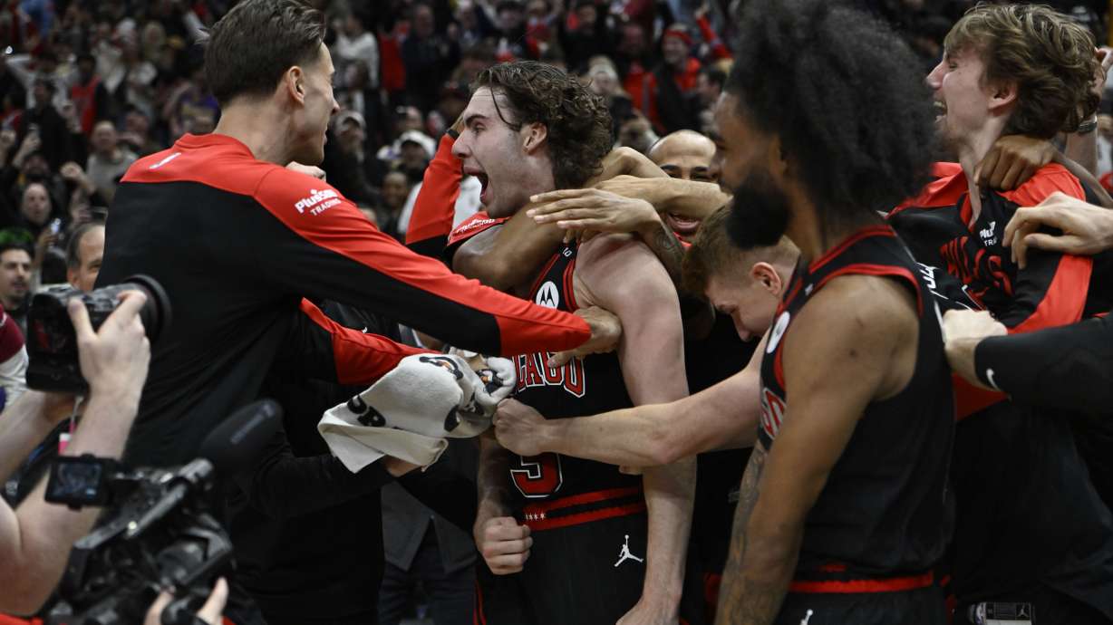 Chicago Bulls' Josh Giddy (3) celebrates with teammates after making the winning basket in an NBA basketball game against the Los Angeles Lakers Thursday, March 27, 2025, in Chicago.