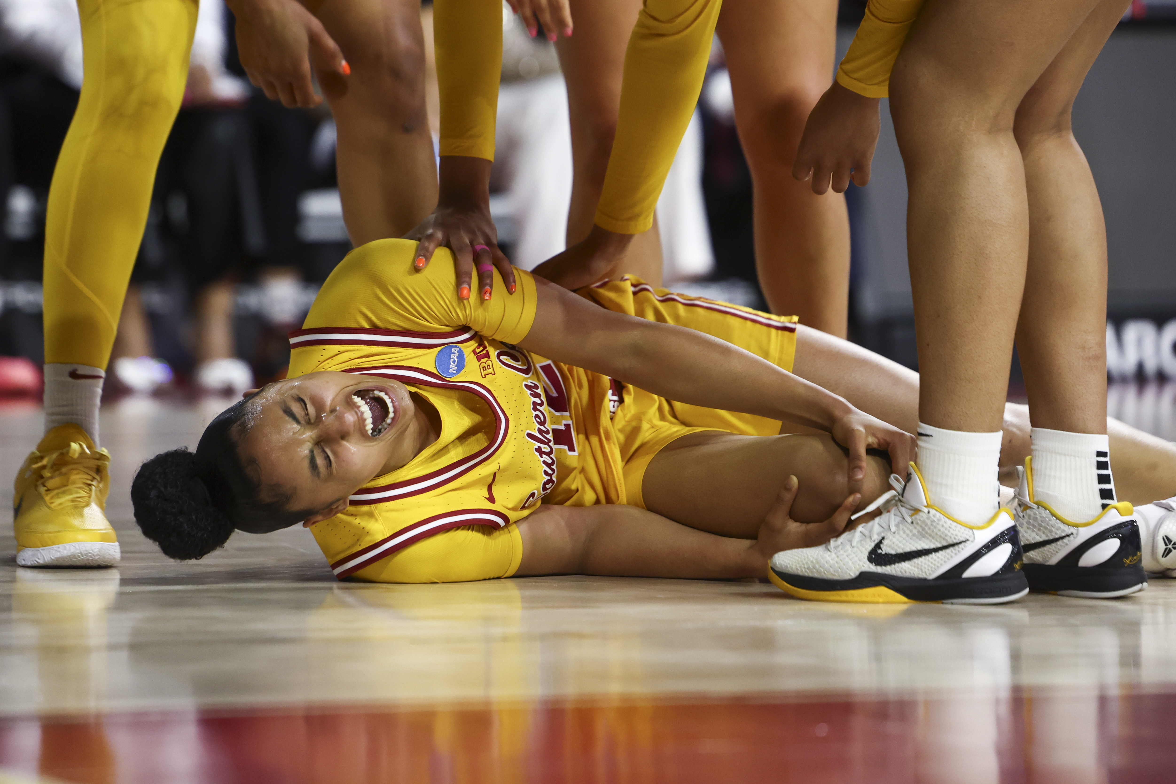 Southern California guard JuJu Watkins (12) reacts on the floor after an injury during the first half against Mississippi State in the second round of the NCAA college basketball tournament Monday, March 24, 2025, in Los Angeles.
