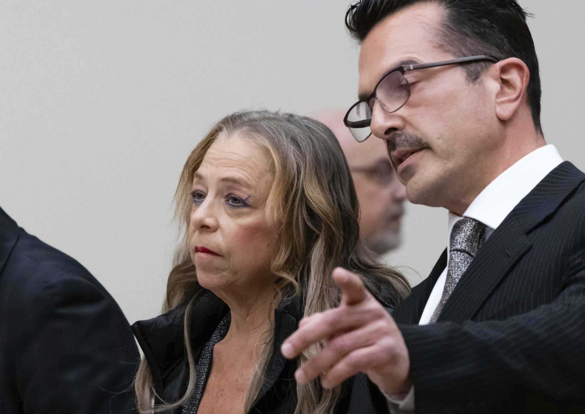 Kim Sullivan, who is charged with neglect, stands with her attorney Ioannis Kaloidis, right, during her arraignment, March 12, at Waterbury Superior Court in Waterbury, Conn.