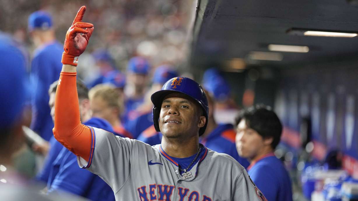 New York Mets' Juan Soto (22) celebrates in the dugout after hitting a home run against the Houston Astros during the third inning of a baseball game Friday, March 28, 2025, in Houston.