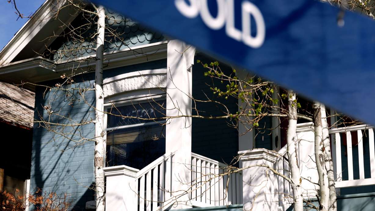 A historical home in the Avenues neighborhood is marked as “sold” in Salt Lake City on Thursday. The price of housing is causing significant numbers of Utahns to consider leaving the state, a new poll showed.