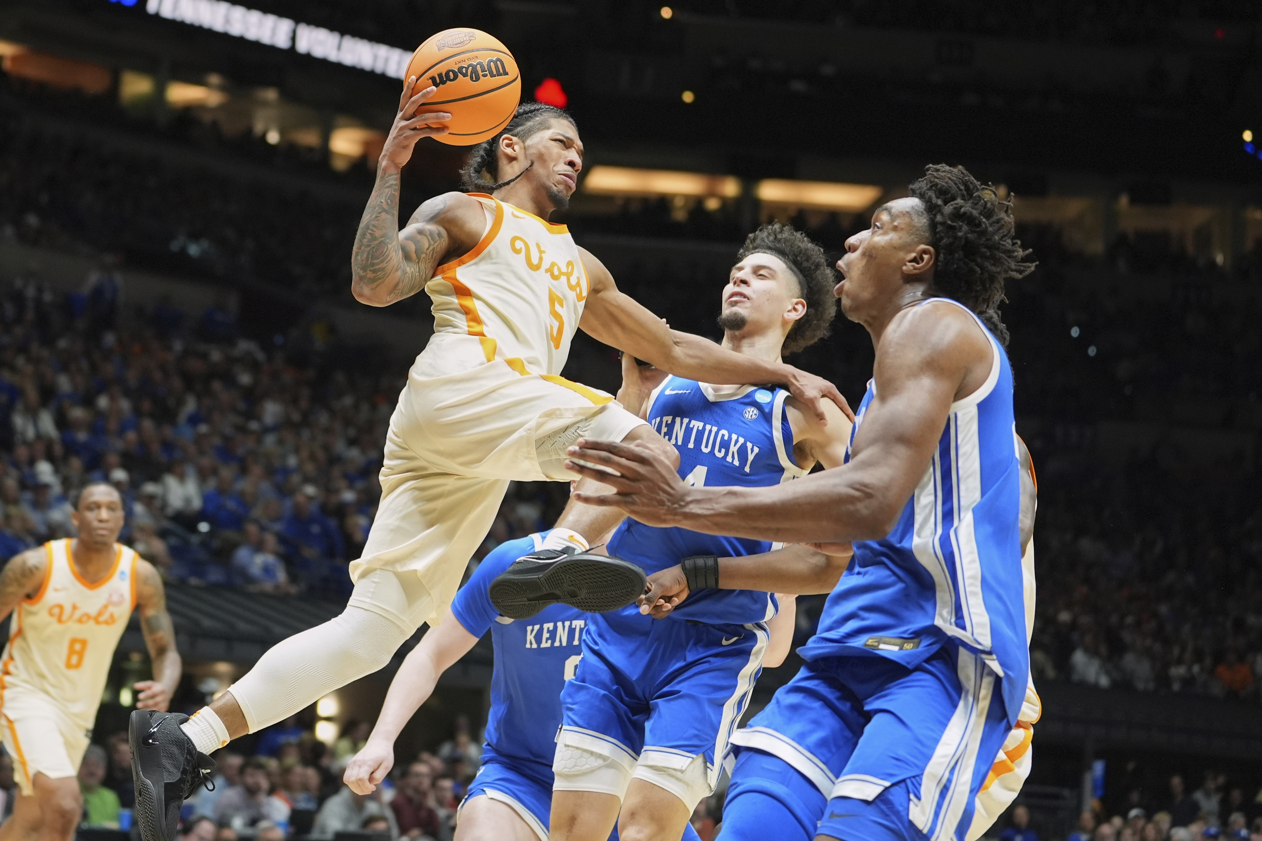 Tennessee's Zakai Zeigler (5) heads to the basket past Kentucky's Koby Brea, center, and Amari Williams, right, during the second half in the Sweet 16 of the NCAA college basketball tournament Friday, March 28, 2025, in Indianapolis.