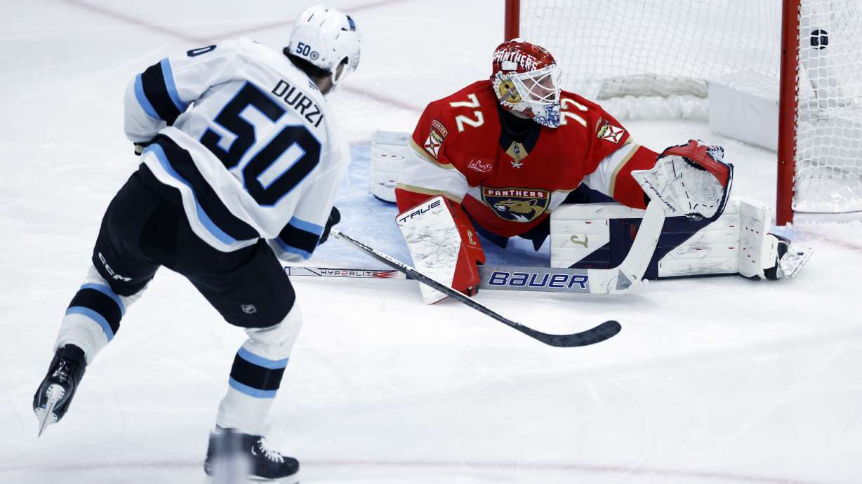 Utah Hockey Club defenseman Sean Durzi scores against Florida Panthers goaltender Sergei Bobrovsky (72) during the third period of an NHL hockey game Friday, March 28, 2025, in Sunrise, Fla.
