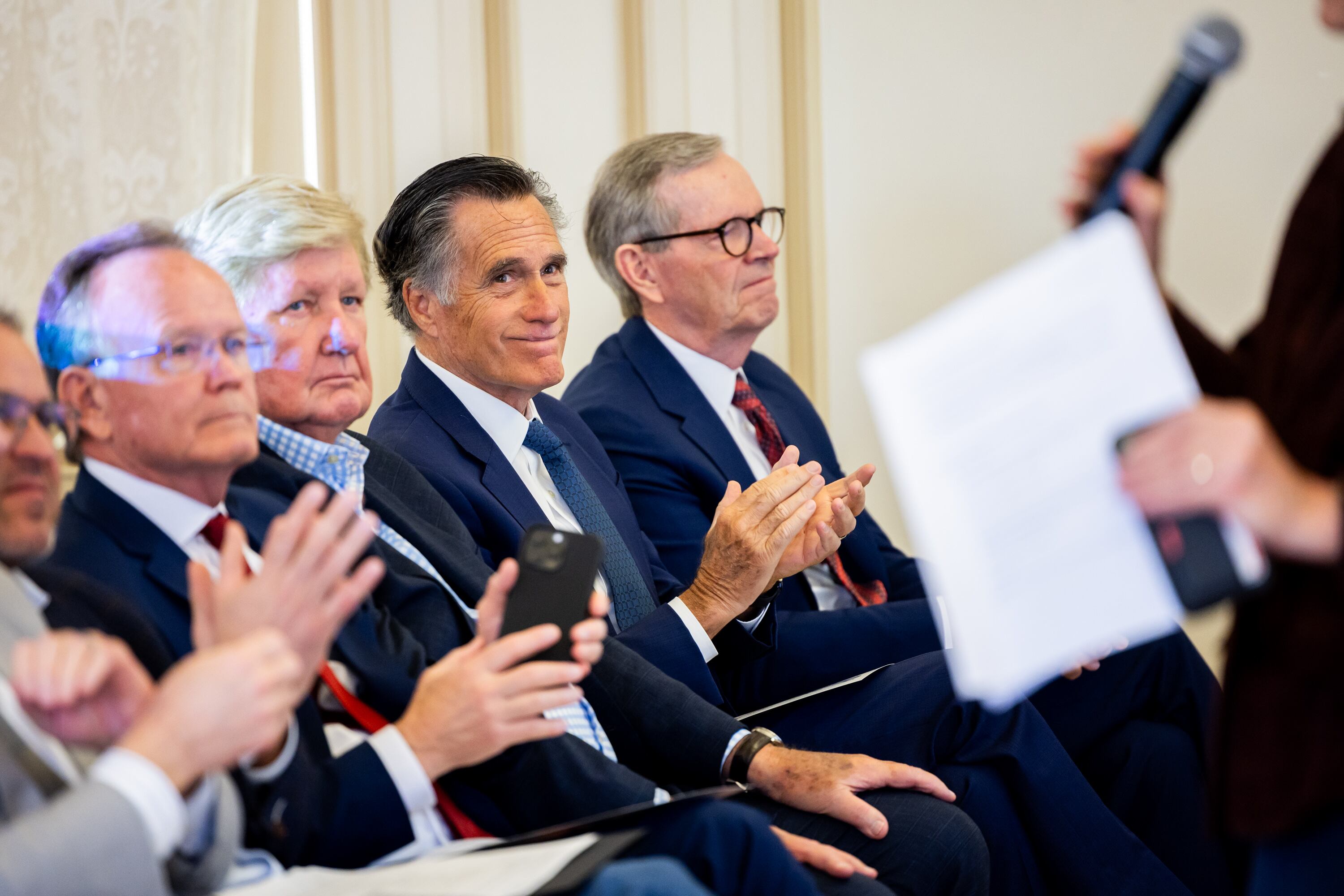 Former U.S. Sen. Mitt Romney claps after Harvard economist and scholar Raj Chetty discussed economic opportunity and upward mobility in Utah at the Thomas S. Monson Center in Salt Lake City on Thursday.