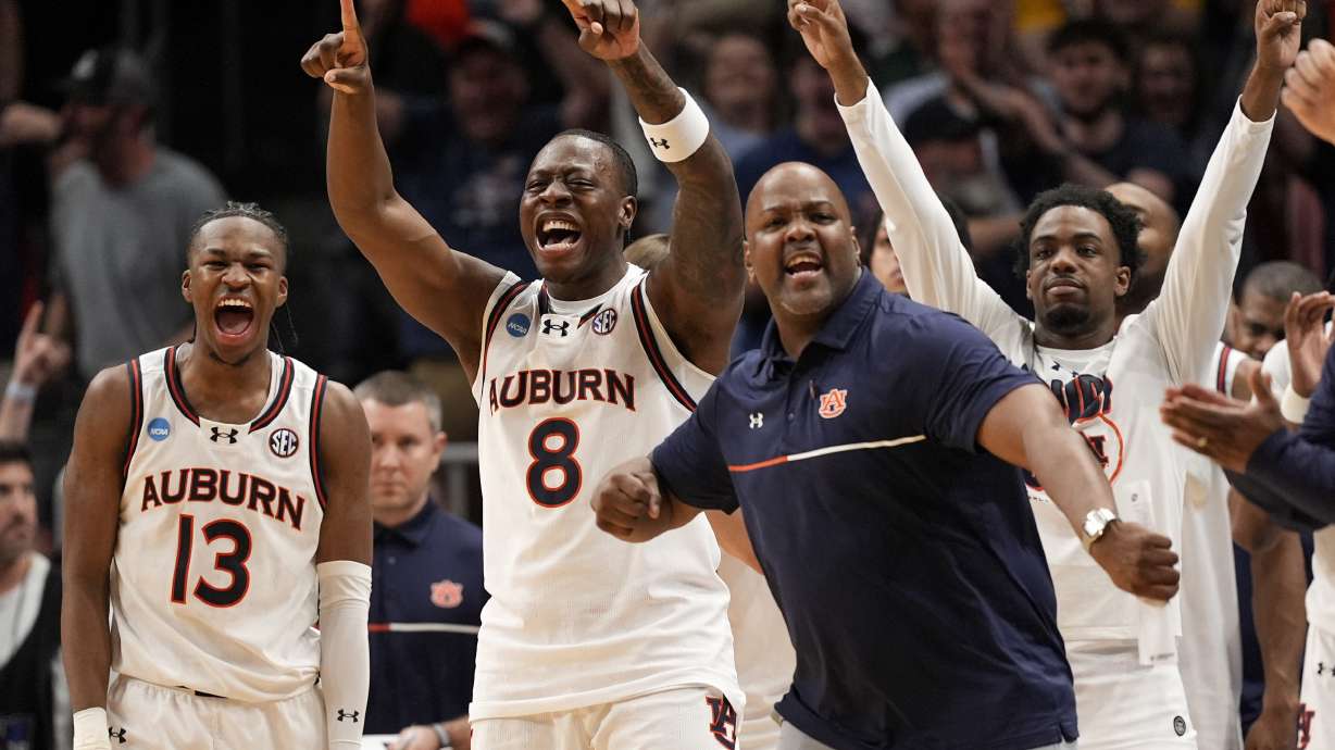 The Auburn bench celebrates during the second half in the Sweet 16 of the NCAA college basketball tournament against Michigan, Saturday, March 29, 2025, in Atlanta.