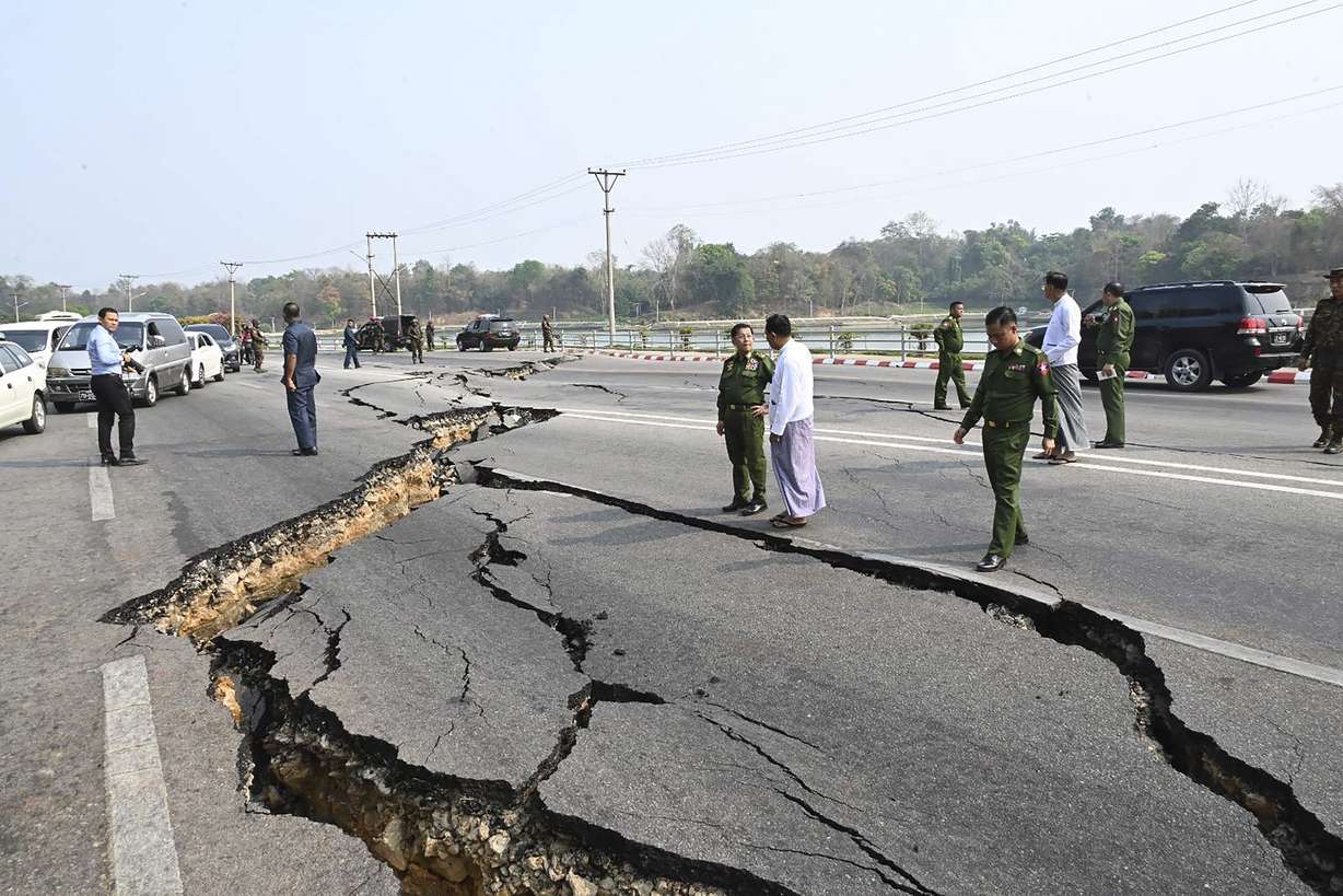 In this image provided by The Myanmar Military True News Information Team, Myanmar's military leader Senior Gen. Min Aung Hlaing, center, inspects damaged road caused by an earthquake Friday in Naypyitaw, Myanmar.