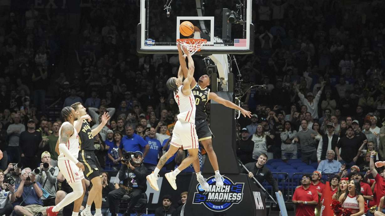 Houston's Milos Uzan (7) scores past Purdue's C.J. Cox (0) with less than a second left during the second half in the Sweet 16 of the NCAA college basketball tournament Saturday, March 29, 2025, in Indianapolis.