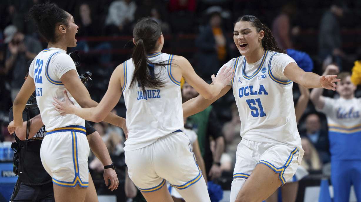 UCLA center Lauren Betts (51) runs to guard Gabriela Jaquez (11) and forward Kendall Dudley (22) as they celebrate after the Sweet 16 of the NCAA college basketball tournament against Mississippi, Friday, March 28, 2025, in Spokane, Wash.