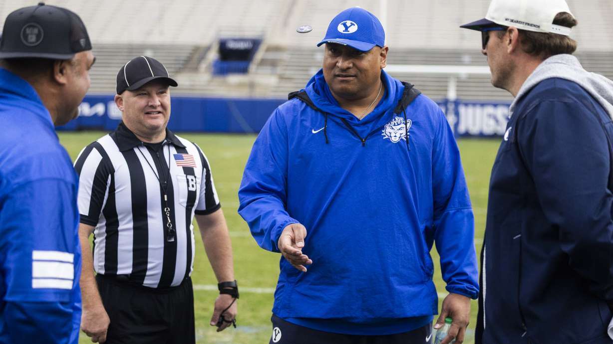 BYU football head coach Kalani Sitake flips a coin to start the BYU alumni game at LaVell Edwards Stadium at BYU in Provo on Friday, March 28, 2025. Team Navy won the alumni game with a final score of 25-20.