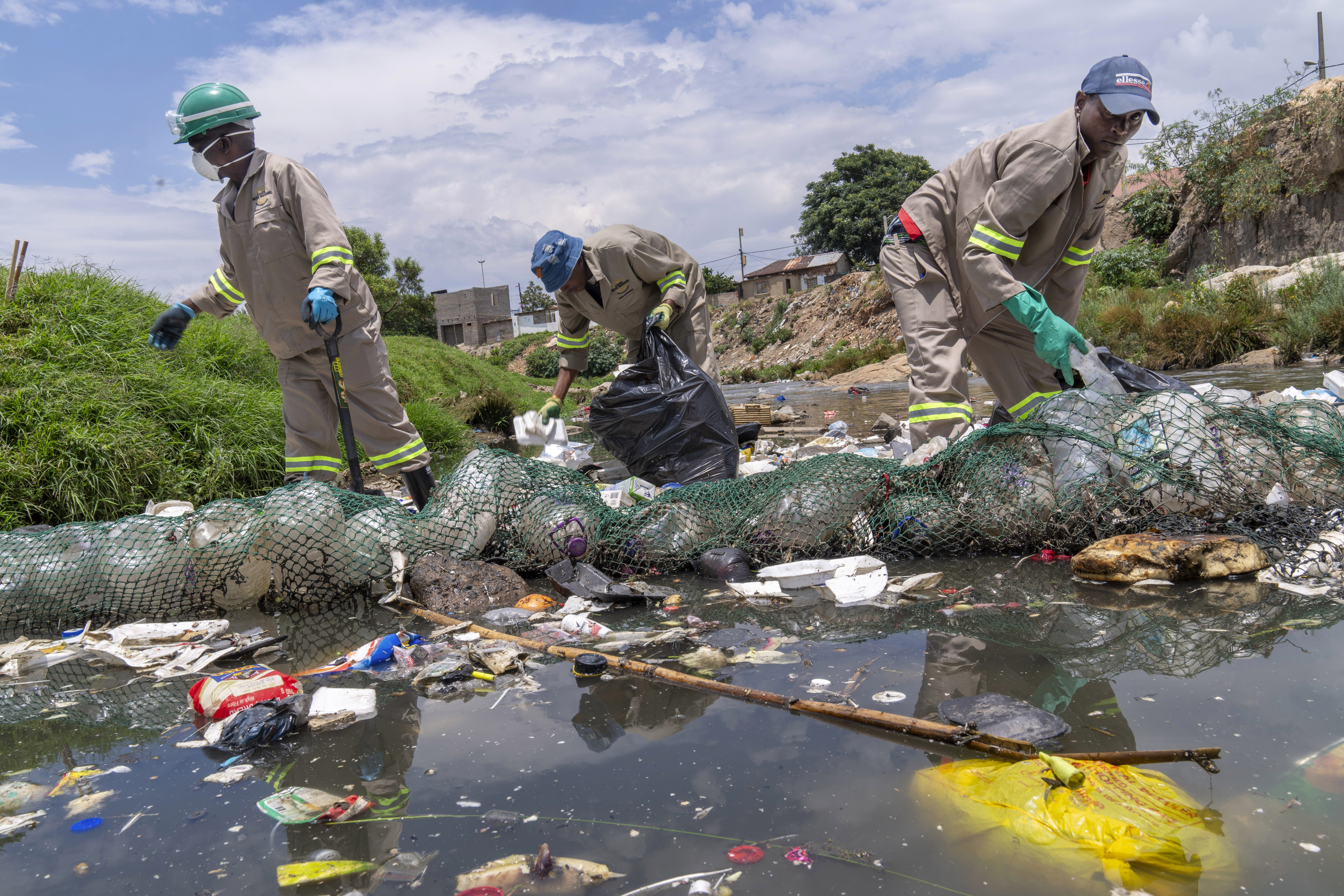 Alexandra Water Warriors volunteers clean up the Juksei River in the heart of Alexandra township from plastic pollution in Johannesburg, South Africa, Nov. 27, 2024.
