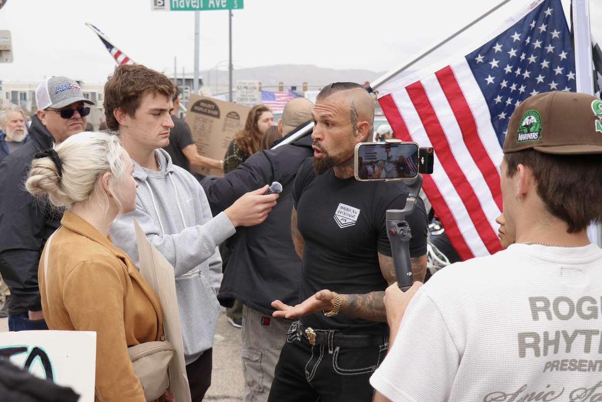 Rival demonstrators oppose anti-Elon Musk protesters outside a Tesla dealership in South Salt Lake during a demonstration on Saturday. It was part of a global "Tesla Takedown" taking place at many company locations.