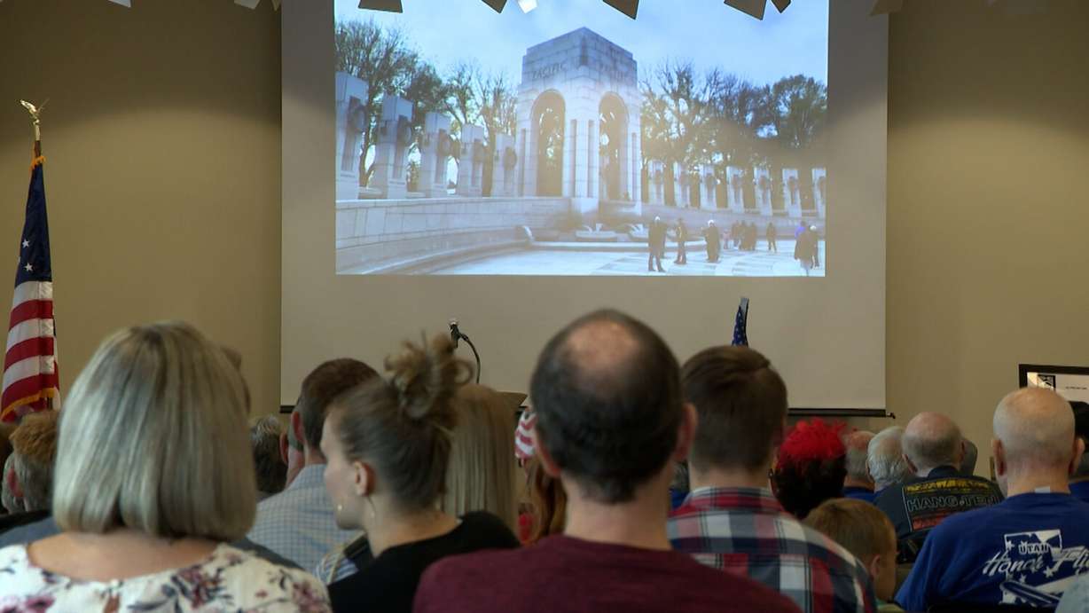 Veterans watch a presentation of pictures and videos of U.S. war memorials.