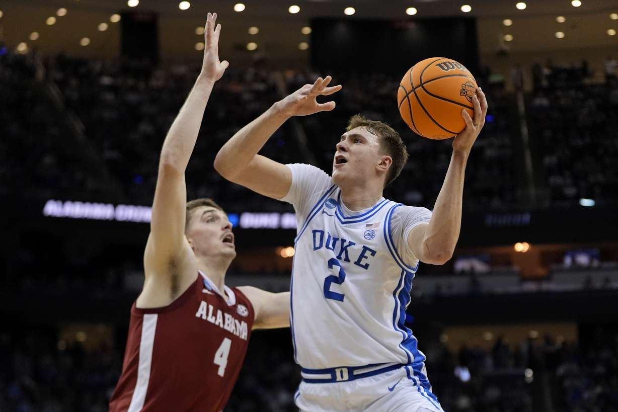Duke forward Cooper Flagg (2) puts up a shot against Alabama guard Aden Holloway (2) during the first half of an Elite Eight round NCAA college basketball tournament game, Saturday, March 29, 2025, in Newark, N.J.