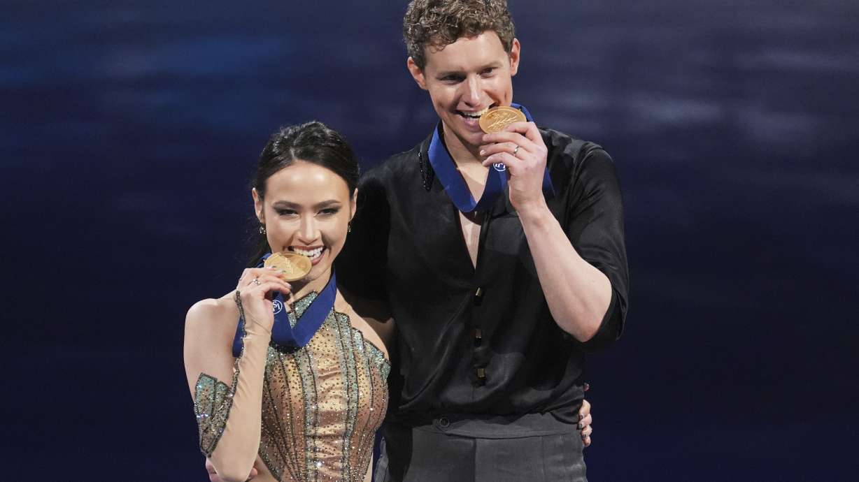 Gold medalists Madison Chock and Evan Bates, of the United States, pose for a photos during a medal ceremony for ice dancing at the figure skating world championships, Saturday, March 29, 2025, in Boston.
