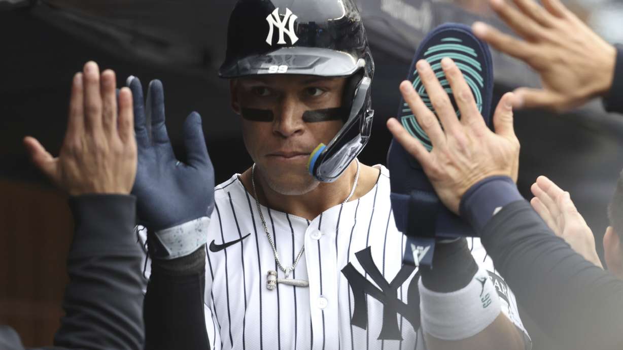 New York Yankees' Aaron Judge reacts after scoring on a wild pitch by Milwaukee Brewers' pitcher Jared Koenig during the sixth inning of a baseball game, Sunday, March 30, 2025, in New York.