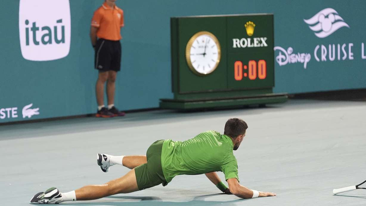 Novak Djokovic, of Serbia, slips and falls as he plays Jakub Mensik, of Czech Repbulic, in the men's singles final match at the Miami Open tennis tournament, Sunday, March 30, 2025, in Miami Gardens, Fla.