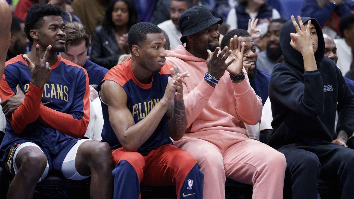 New Orleans Pelicans center Yves Missi, left, forward Jamal Cain, forward Zion Williamson and guard Dejounte Murray applaud for their teammates during the second half of an NBA basketball game against the Philadelphia 76ers in New Orleans, Monday, March 24, 2025.