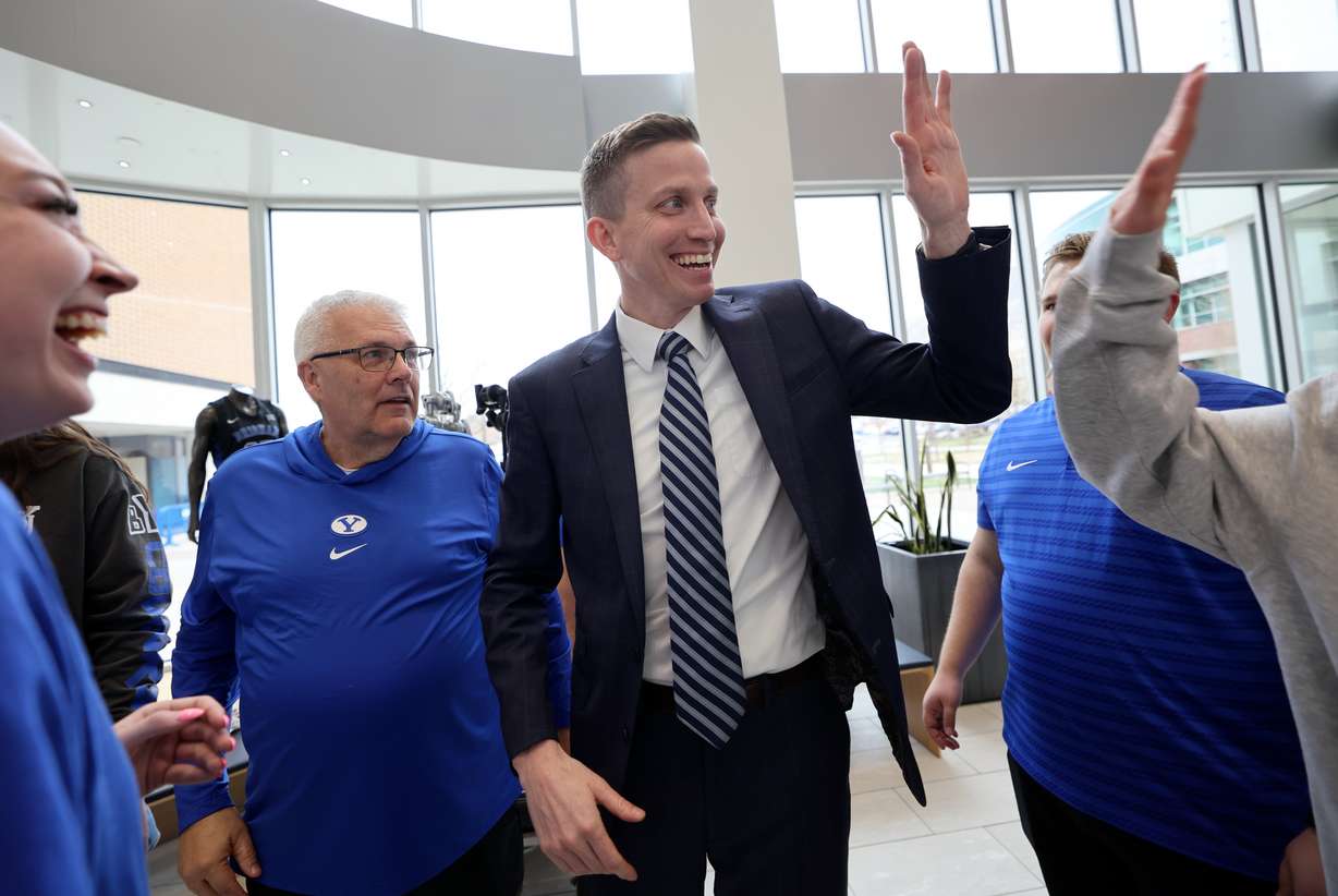 Lee Cummard gets high fives after a press conference to introduce him as the new BYU women’s basketball head coach at the Marriott Center Annex in Provo on Monday, March 31, 2025.