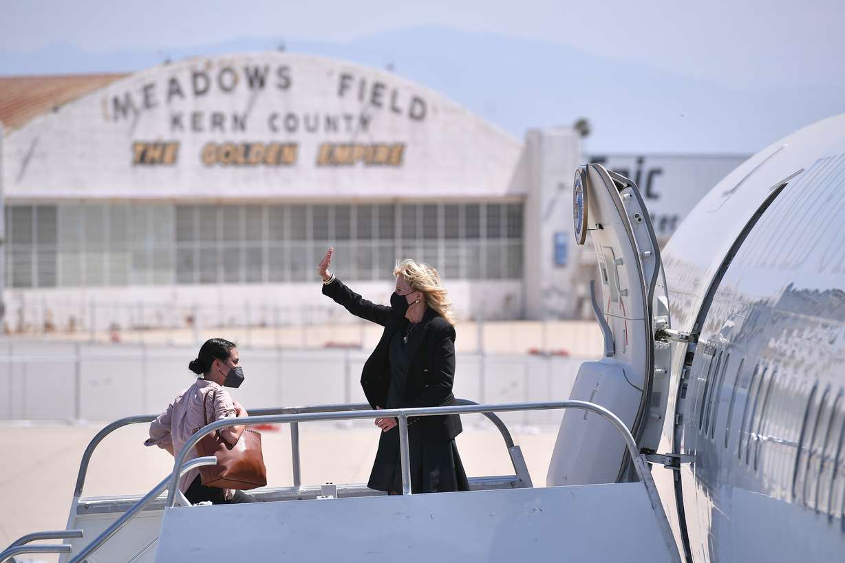 First lady Jill Biden waves as she boards a plane before departing from Meadows Field Airport in Bakersfield, Calif., April 1, 2021. She pretended to be a flight attendant on an airplane traveling from California to Washington.
