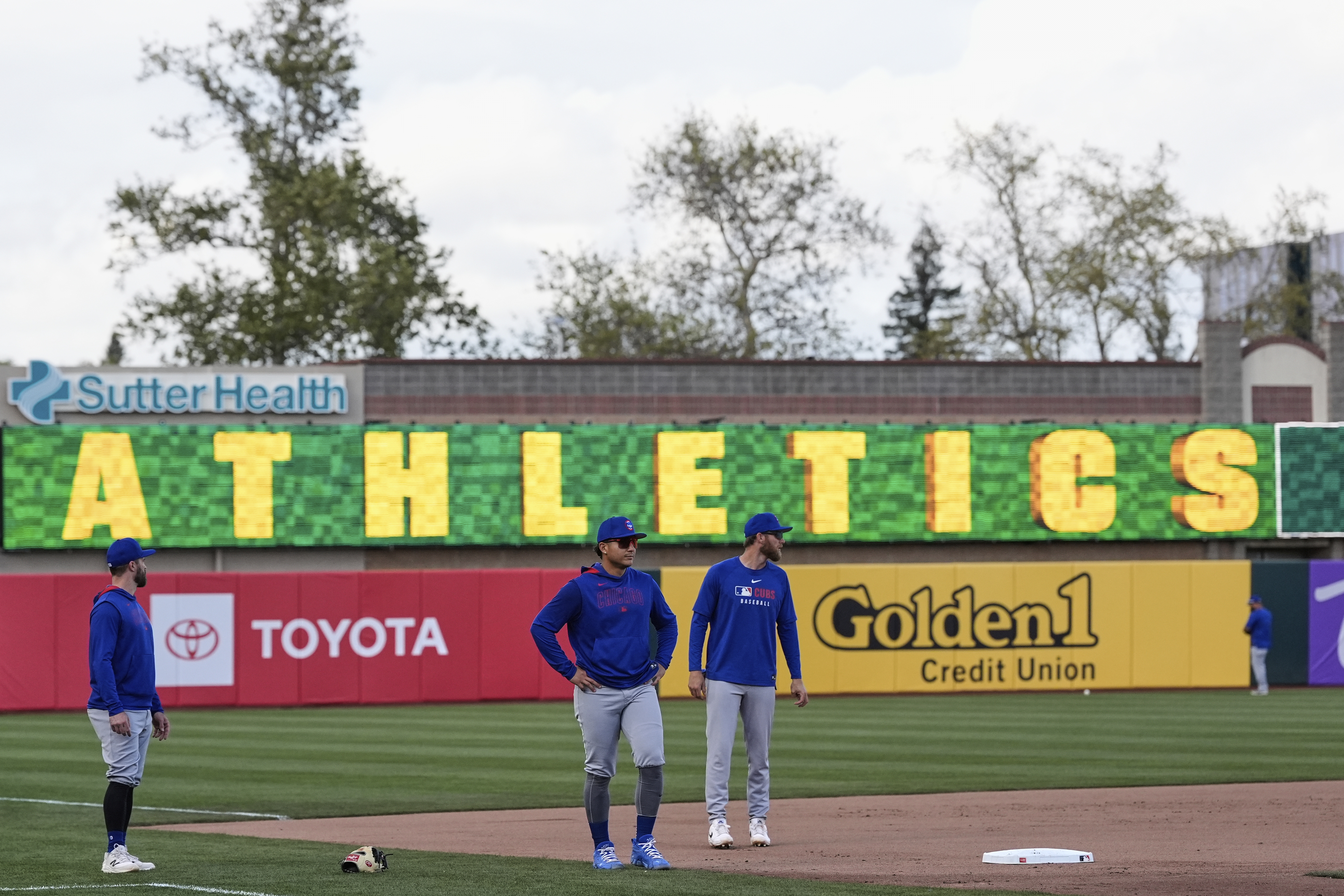 Chicago Cubs players warm up before a baseball game against the Athletics, Monday, March 31, 2025, in West Sacramento, Calif.