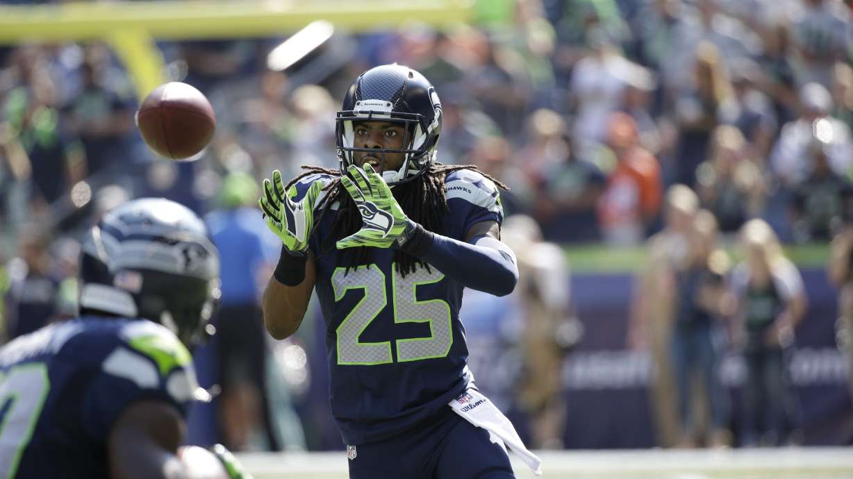FILE - Seattle Seahawks cornerback Richard Sherman takes part in warmups before an NFL football game against the Denver Broncos, Sunday, Sept. 21, 2014, in Seattle.