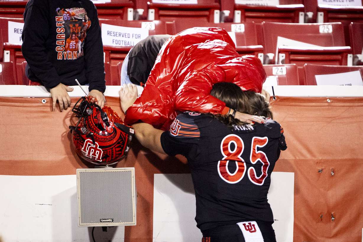 Utah tight end Carsen Ryan (85) hugs his mother, Danielle Ryan, after the Utes were defeated by the Iowa State Cyclones in an NCAA football game held at Rice-Eccles Stadium in Salt Lake City on Saturday, Nov. 23, 2024.