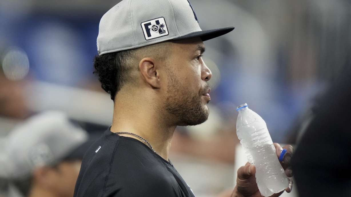 New York Yankees' Giancarlo Stanton looks out from the dugout during an exhibition baseball game against the Miami Marlins, Tuesday, March 25, 2025, in Miami.