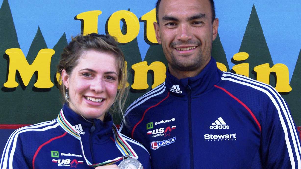 FILE - In this 2009 photo provided by Karen Gorman, biathlete Grace Boutot, left, of Fort Kent, Maine, displays her silver medal from the Youth Women Biathlon World Championships, while standing with coach Gary Colliander, right, in Fort Kent.