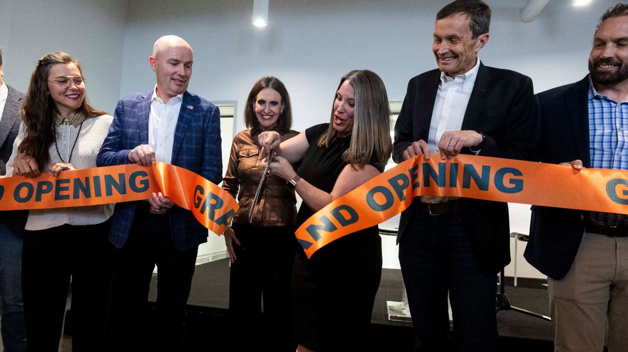 Leah Frautschy of Denali Therapeutics, center, cuts a ribbon opening a new biomedical facility in Salt Lake City on Thursday. Denali Therapeutics develops drugs used in the treatment of neurodegenerative and lysosomal storage diseases.