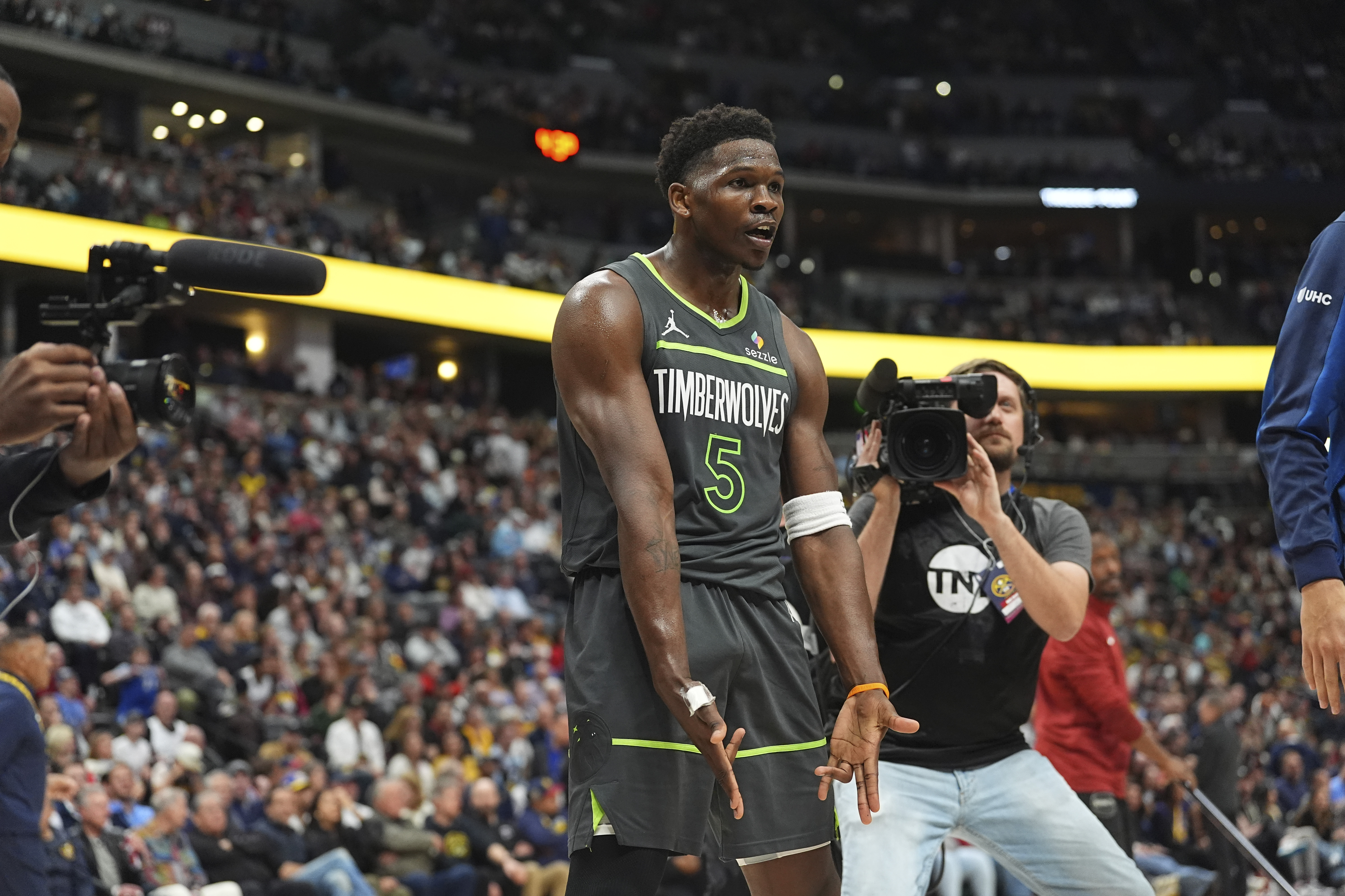 Minnesota Timberwolves guard Anthony Edwards reacts after hitting a basket against the Denver Nuggets in the second half of an NBA basketball game Tuesday, April 1, 2025, in Denver.