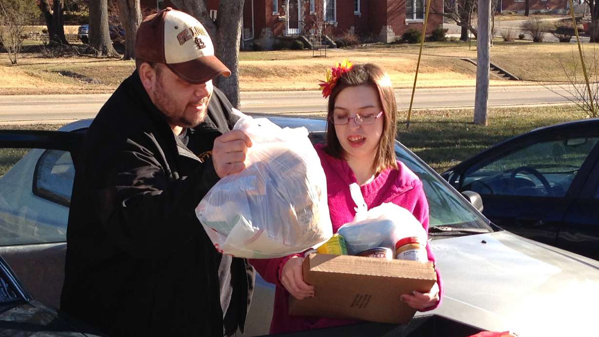 Joe Heflin, left, loads free groceries with the help of a volunteer at a food pantry in Jefferson City, Mo., on Jan. 28, 2016. Legislation co-sponsored by Sen. Mike Lee would increase the requirements necessary to receive Supplemental Nutrition Assistance Program benefits.