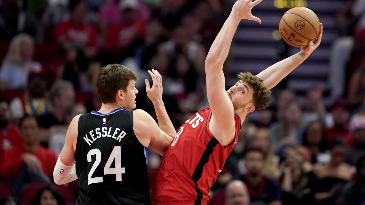 Houston Rockets center Alperen Sengun, right, grabs a rebound over Utah Jazz center Walker Kessler during the second half of an NBA basketball game Wednesday, April, 2, 2025, in Houston.