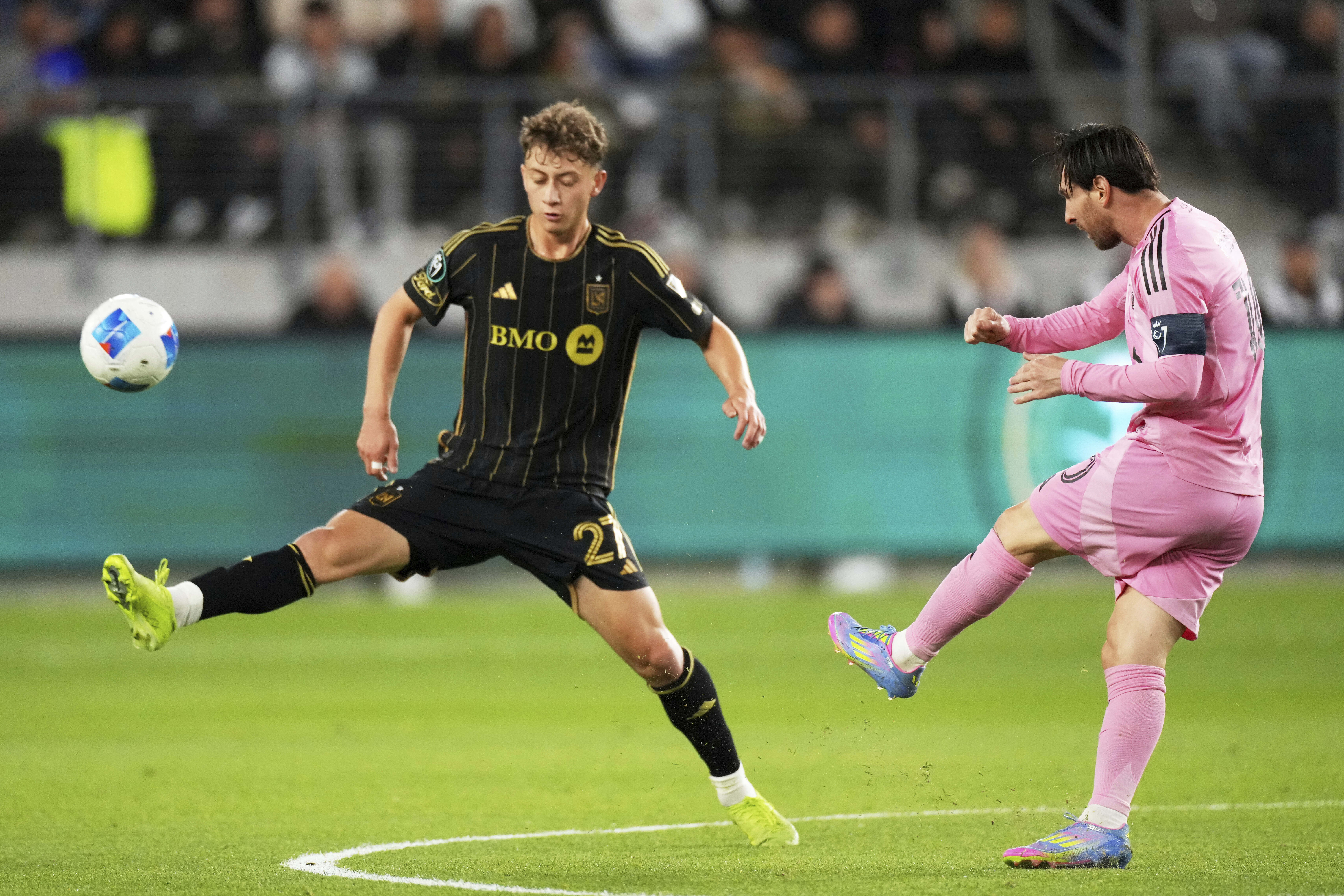 Inter Miami forward Lionel Messi, right, kicks past Los Angeles FC forward Nathan Ordaz during the first half of an MLS soccer match, Wednesday, April 2, 2025, in Los Angeles.