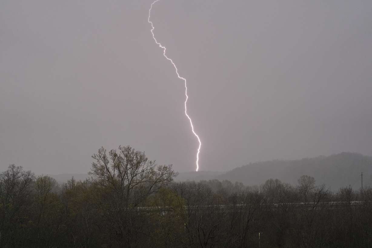 Lightning strikes as storms move through the area Wednesday, in Ashland City, Tenn.