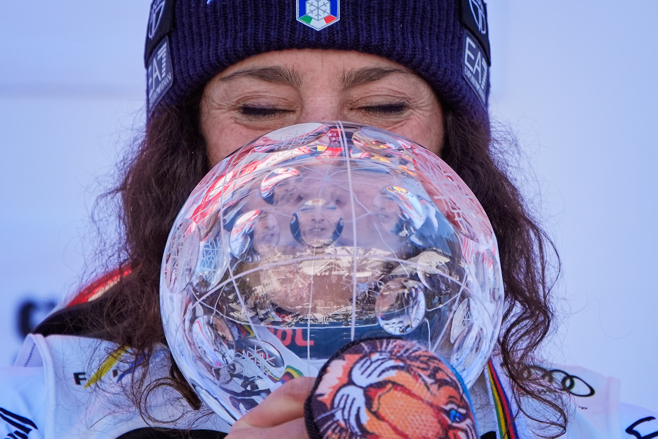 Italy's Federica Brignone is reflected in the crystal globe trophy after winning the women's giant slalom season championship at the World Cup Finals, Tuesday, March 25, 2025, in Sun Valley, Idaho.