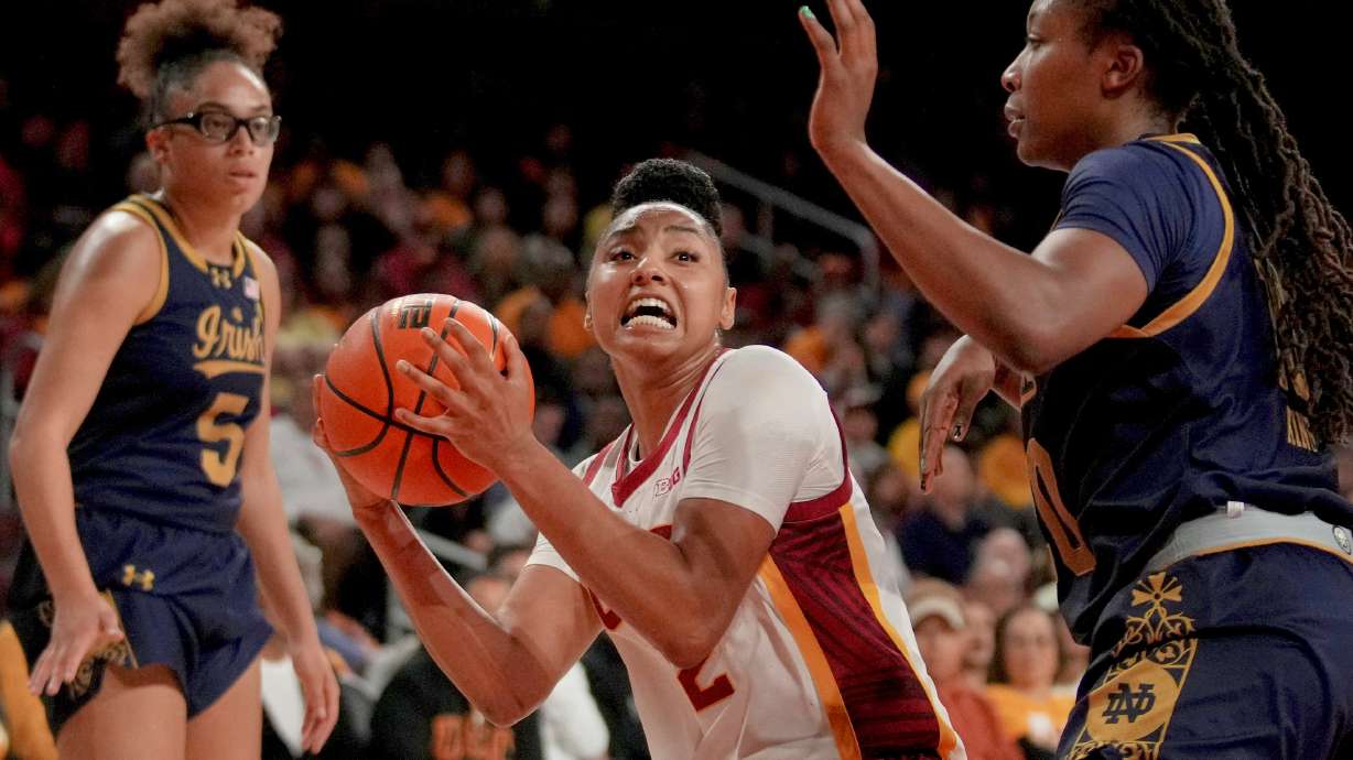 FILE - Southern California guard JuJu Watkins goes to the basket against Notre Dame forward Liatu King as guard Olivia Miles (5) looks on during the second half of an NCAA college basketball game, Saturday, Nov. 23, 2024 in Los Angeles.