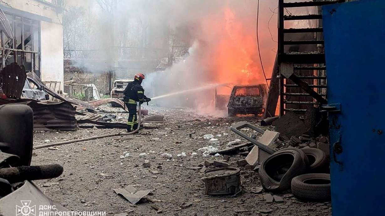 Firefighters put out a fire following a Russian missile attack in Kryvyi Rih, Ukraine, Wednesday. Utah Sen. John Curtis has joined a group of 50 senators supporting sanctions against Russia over the aggression in Ukraine.