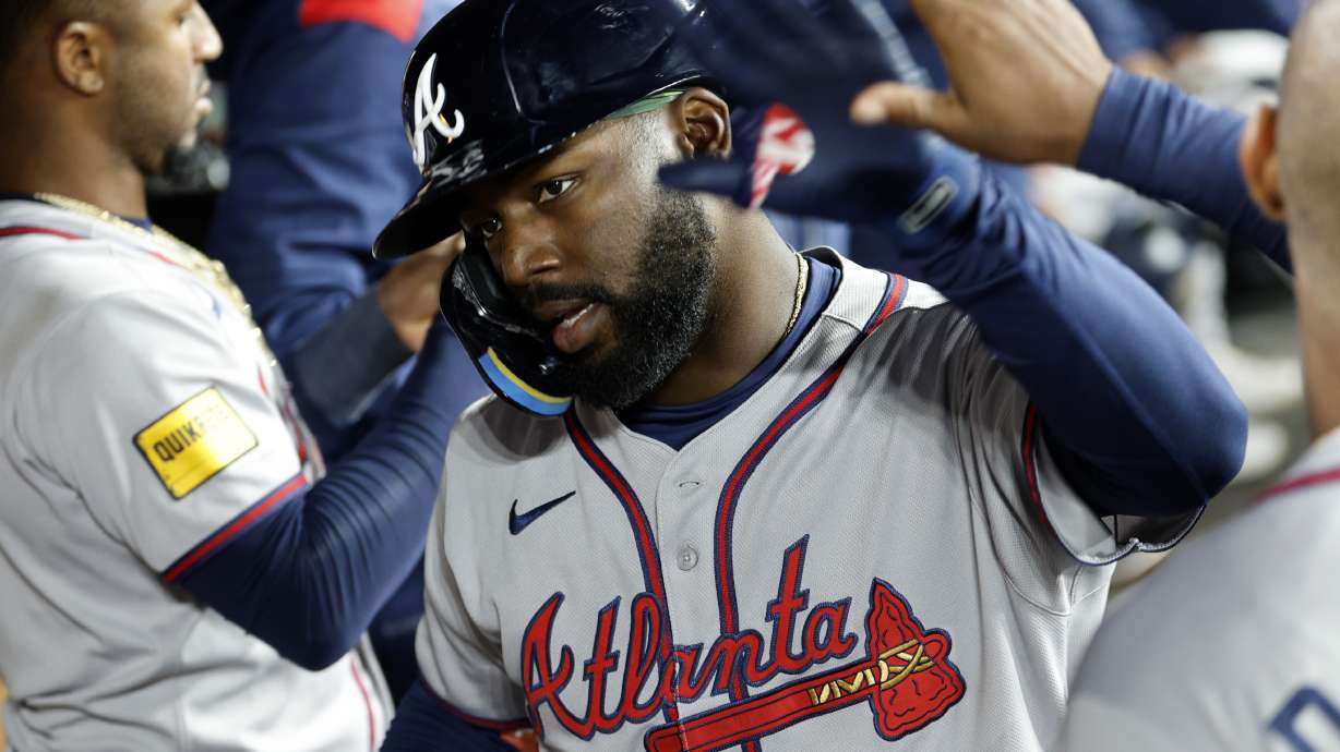 Atlanta Braves' Michael Harris II is congratulated in the dugout after hitting a one-run home run against the Los Angeles Dodgers during the eight inning of a baseball game Monday, March 31, 2025, in, Los Angeles.