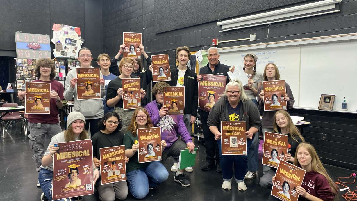 Students hold posters for "Meesical the Musical," a show they created to honor Principal Mike Mees who is retiring from Pine View High School.