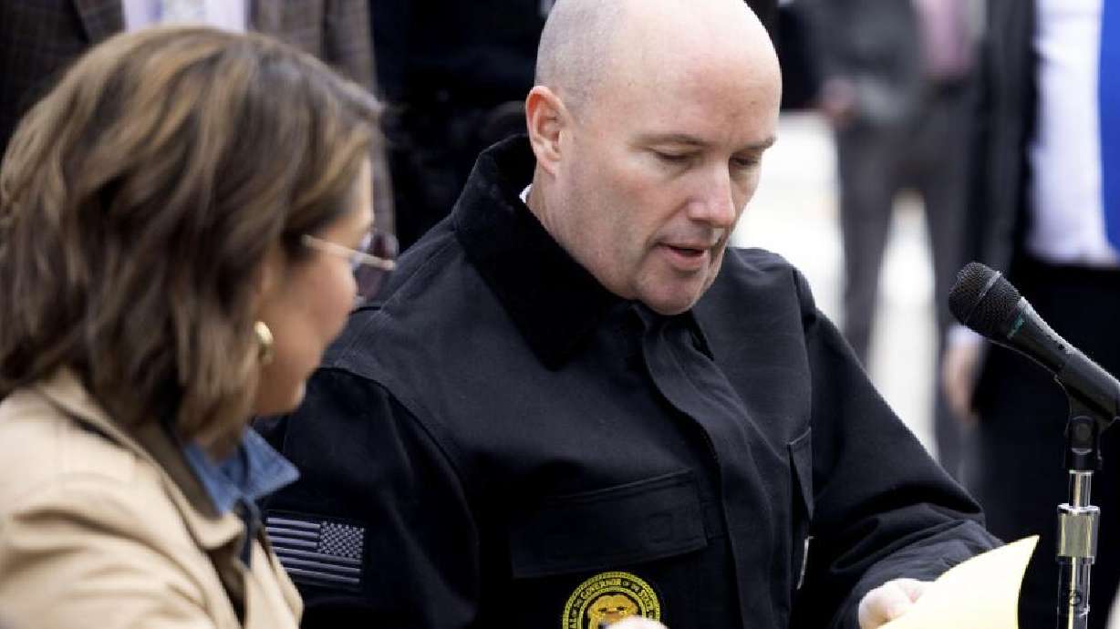 Lt. Gov. Deidre M. Henderson and Gov. Spencer Cox sign public safety legislation outside of the Rio Grande Depot in Salt Lake City on Thursday.