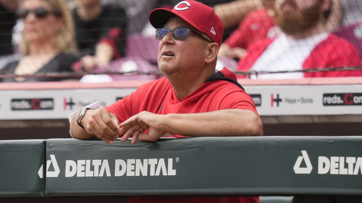 Cincinnati Reds manager Terry Francona watches a fly ball from the dugout railing in the first inning of a baseball game against the Texas Rangers, Wednesday, April 2, 2025, in Cincinnati.