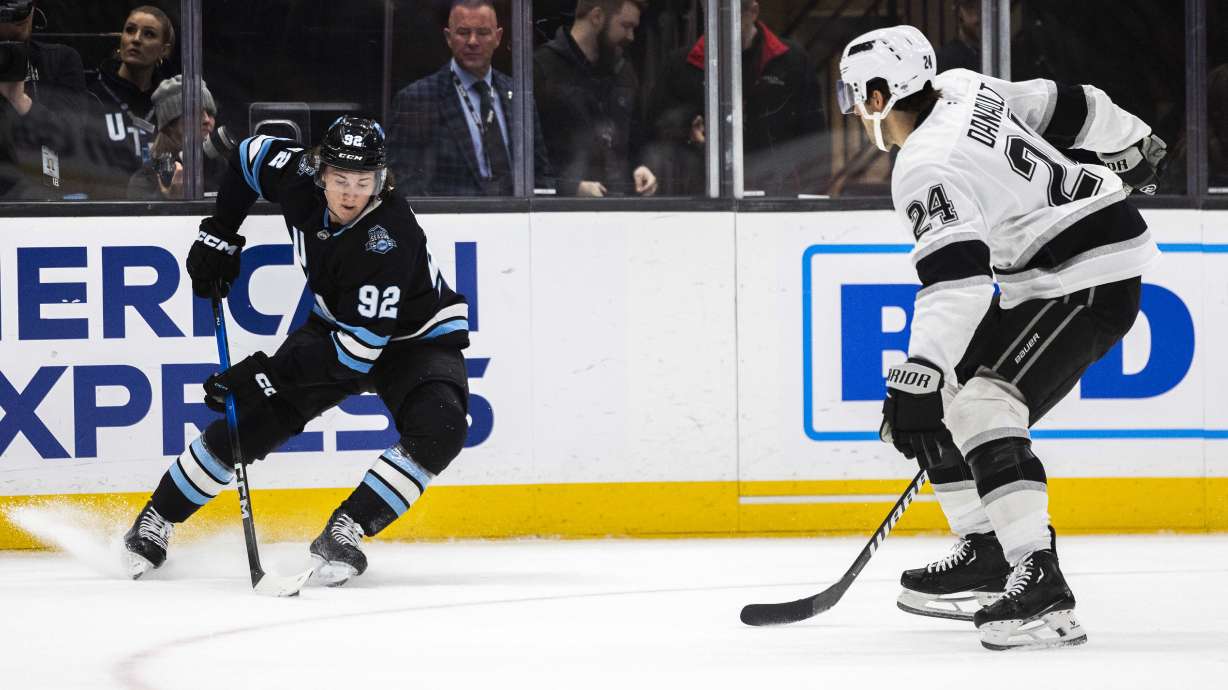 Utah Hockey Club center Logan Cooley (92) controls the puck while making a turn during an NHL game between the Utah Hockey Club and the Los Angeles Kings at the Delta Center in Salt Lake City on Thursday, April 3, 2025.