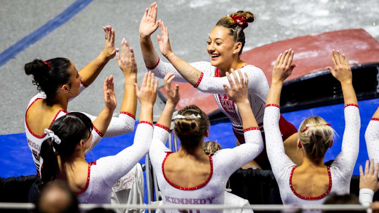 Utah’s Makenna Smith, center, celebrates after performing on the balance beam as they compete in the NCAA regional semifinals for gymnastics at the Jon M. Huntsman Center in Salt Lake City on Thursday, April 3, 2025.
