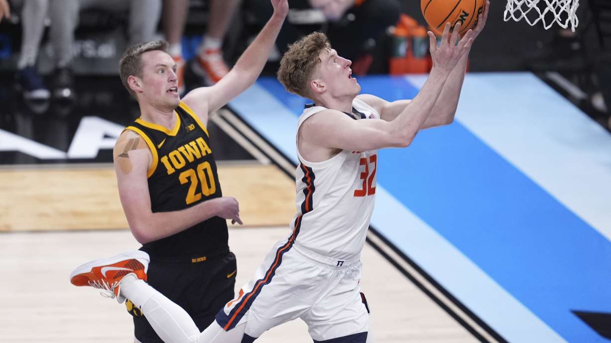 Iowa forward Owen Freeman (32) drives on Iowa forward Payton Sandfort (20) during the second half of an NCAA college basketball game in the second round of the Big Ten Conference tournament in Indianapolis, Thursday, March 13, 2025.