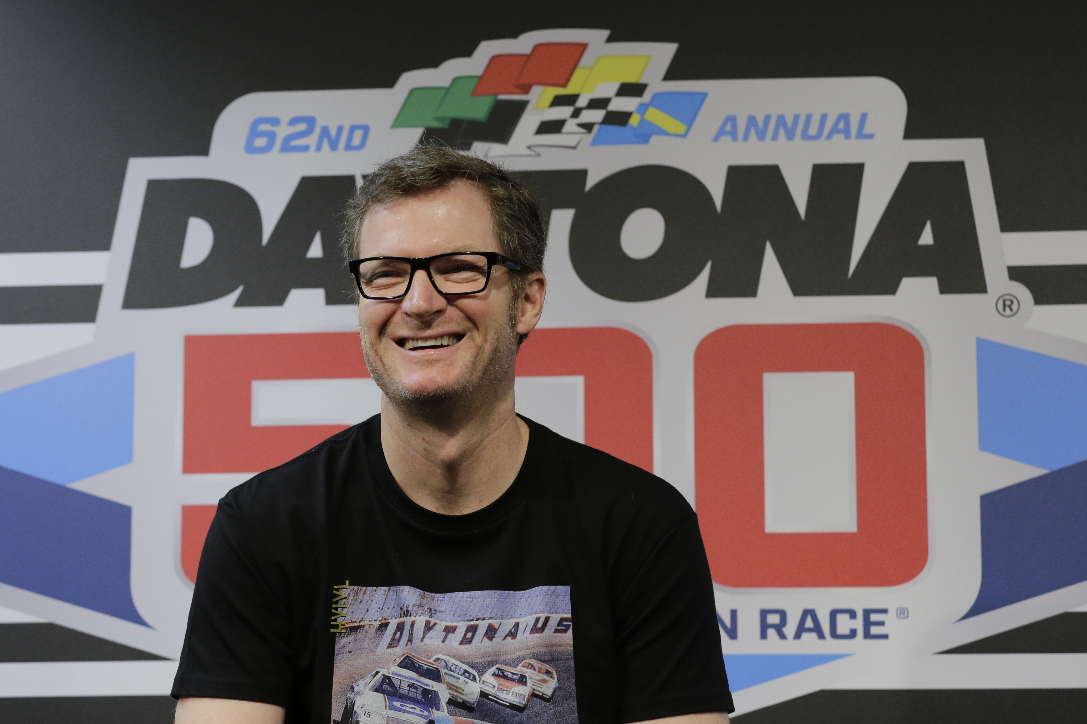 FILE - Dale Earnhardt Jr. answers questions during a news conference before the NASCAR Daytona 500 auto race at Daytona International Speedway, Feb. 16, 2020, in Daytona Beach, Fla.