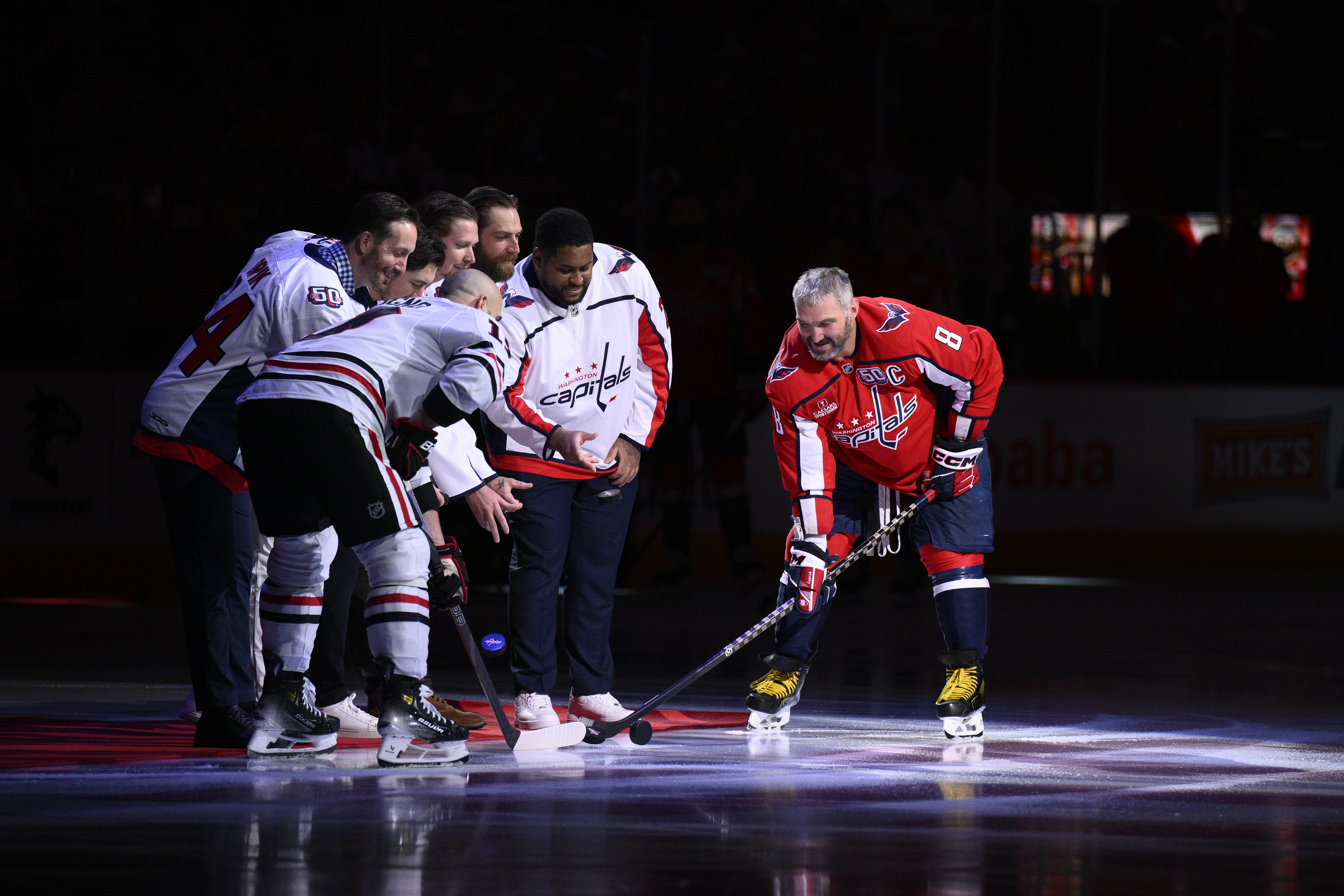 Washington Capitals left wing Alex Ovechkin (8) takes part in the ceremonial puck drop before the start of the first period of an NHL hockey game against the Chicago Blackhawks , Friday, April 4, 2025, in Washington.