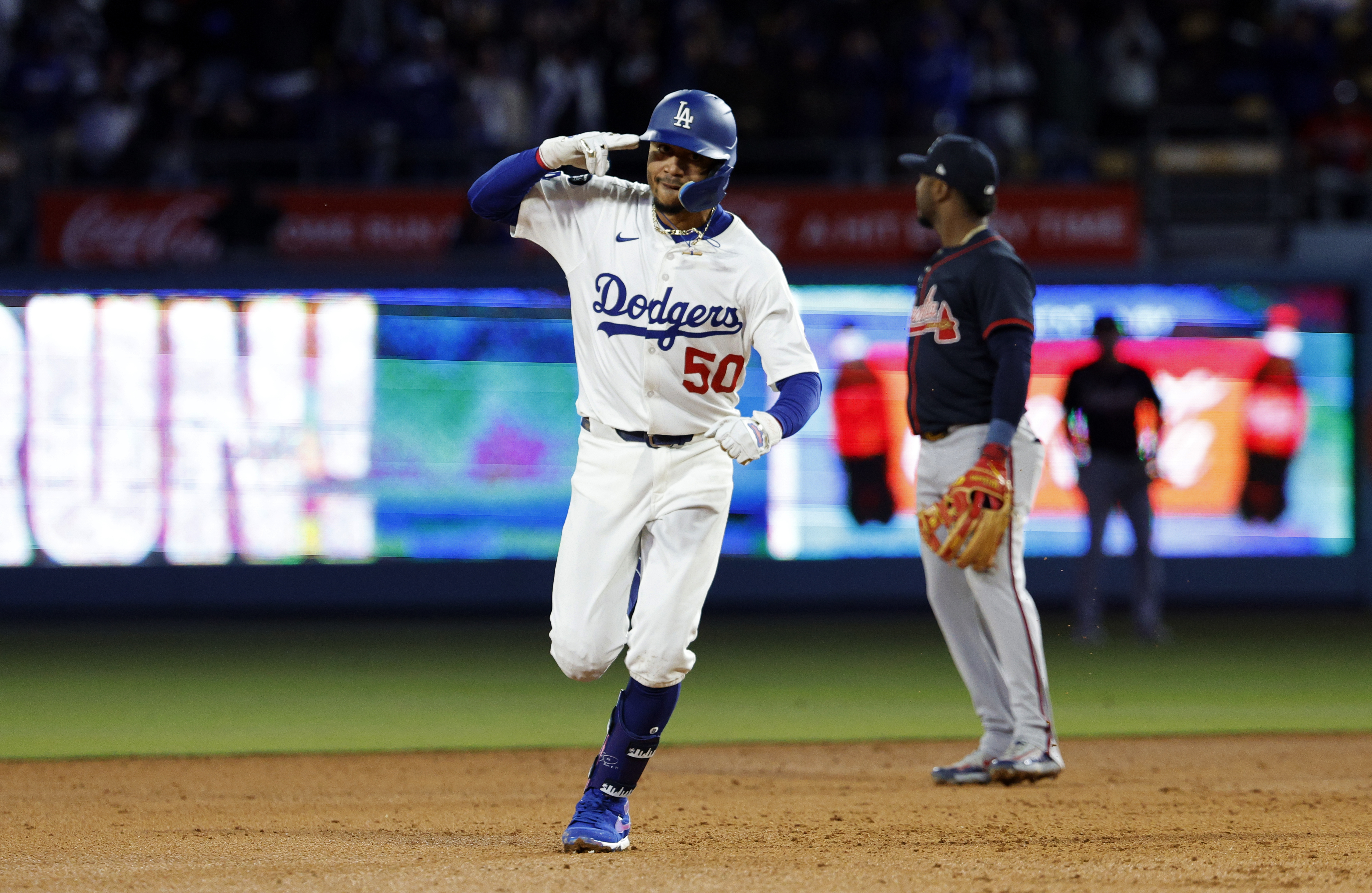 Los Angeles Dodgers' Mookie Betts celebrates after hitting a two-run home run against the Atlanta Braves during the sixth inning of a baseball game Tuesday, April 1, 2025, in, Los Angeles.