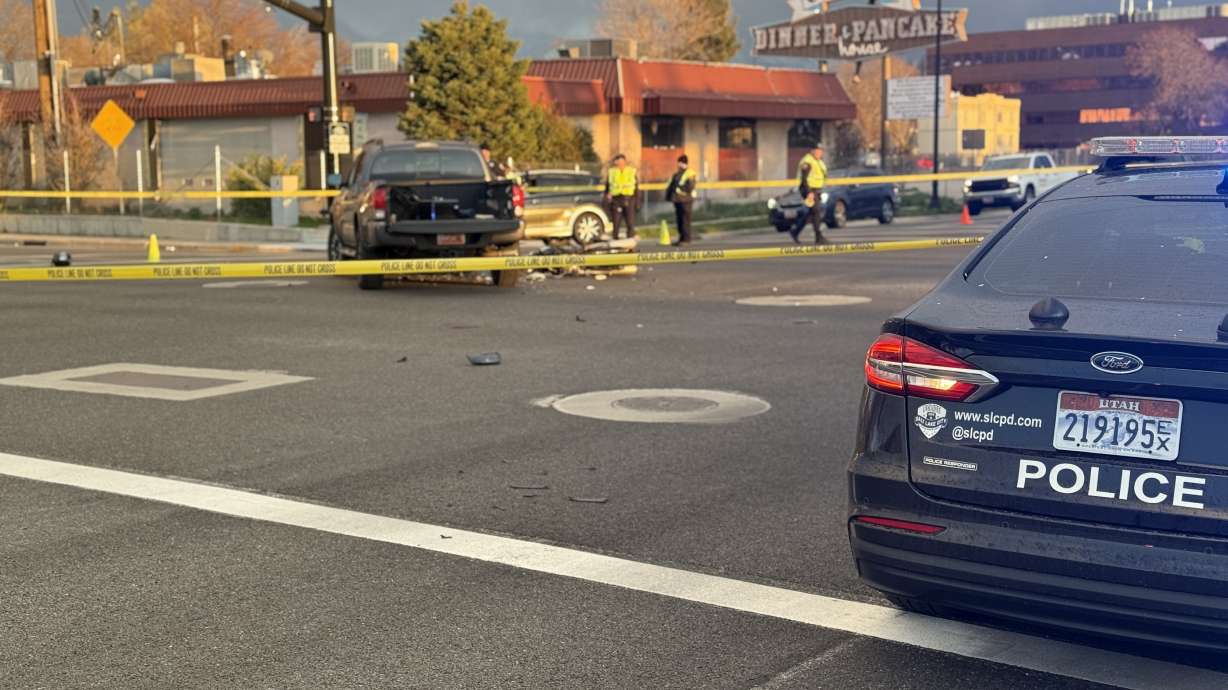 A woman is in critical condition after her motorcycle collided with a car in Salt Lake City Friday.